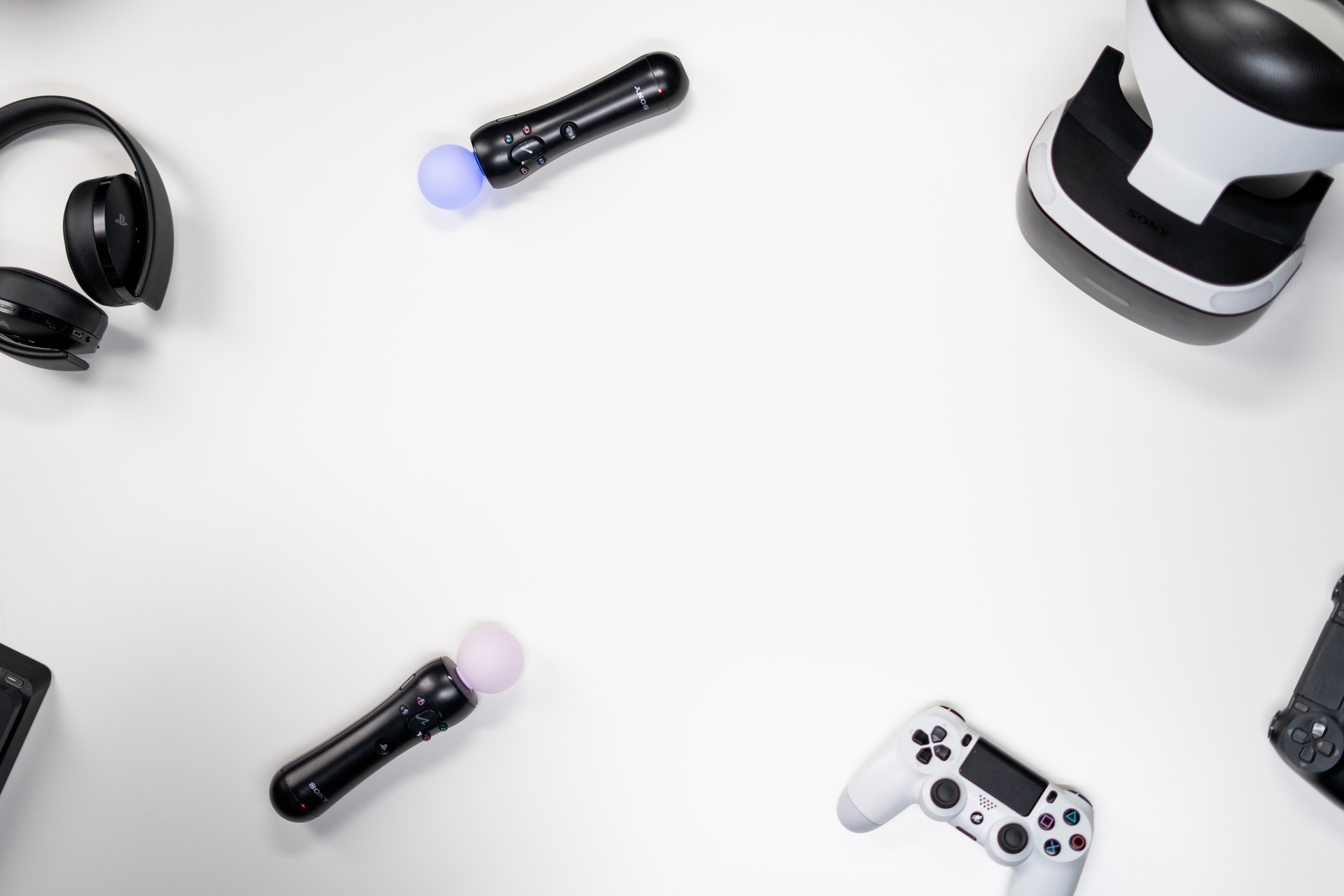 Headphones, Sony Move Controller, and VR headset on a white background