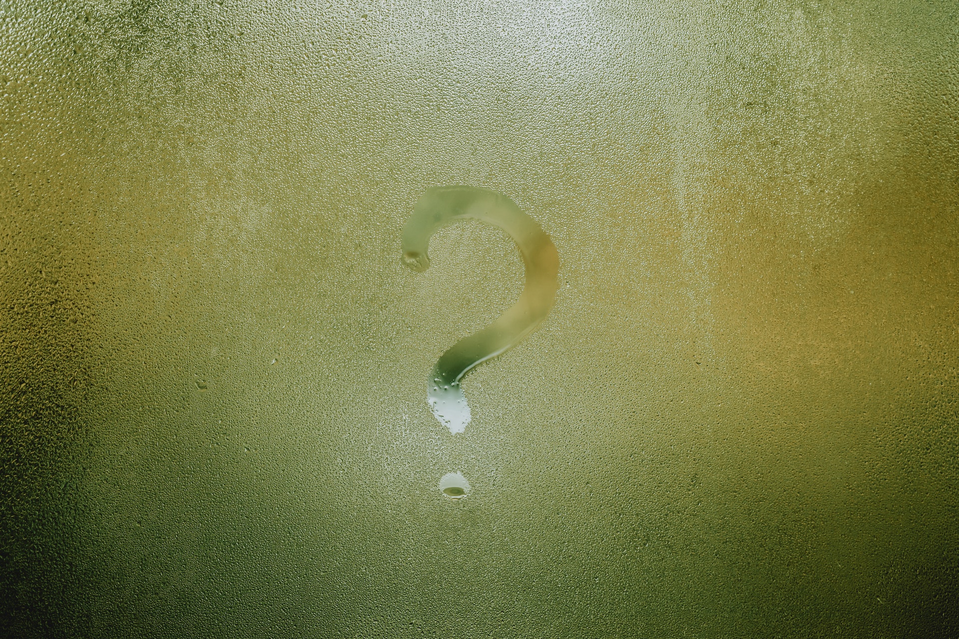Question mark written in condensation on a window