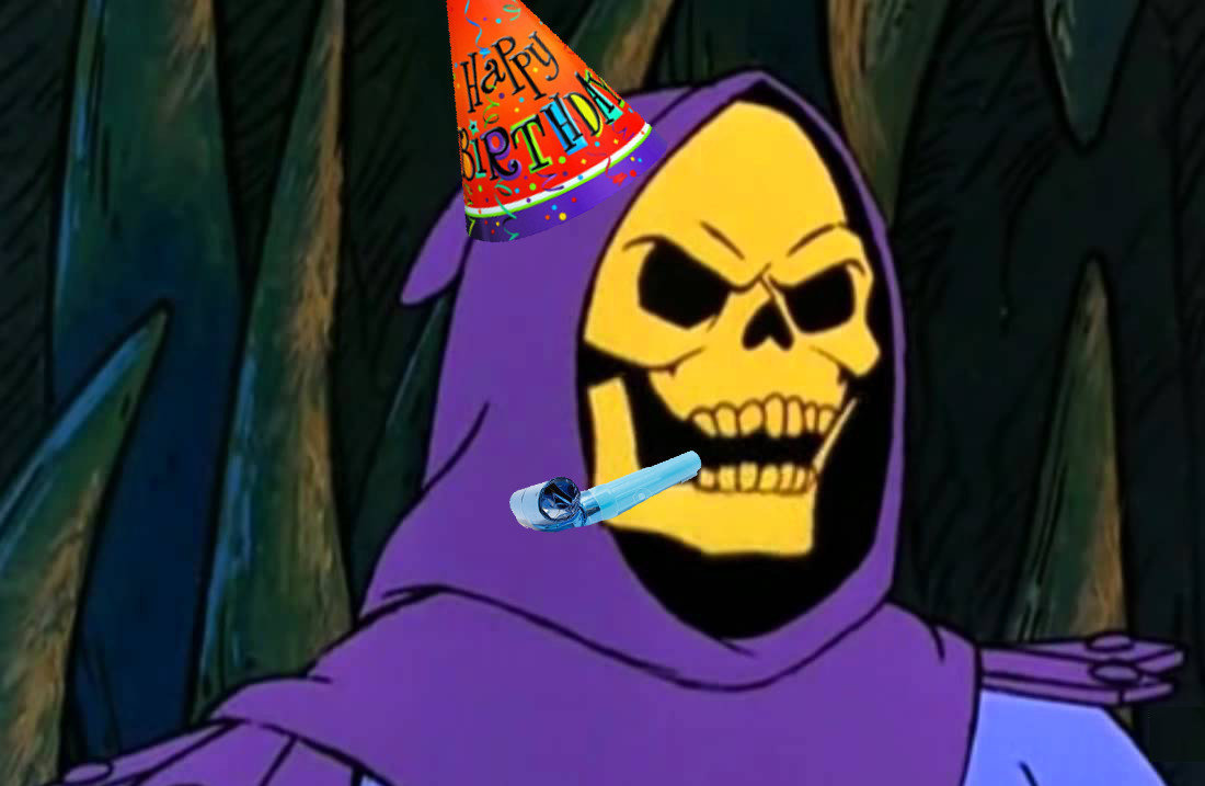 Skeltor, wearing a party hat and blowing a streamer