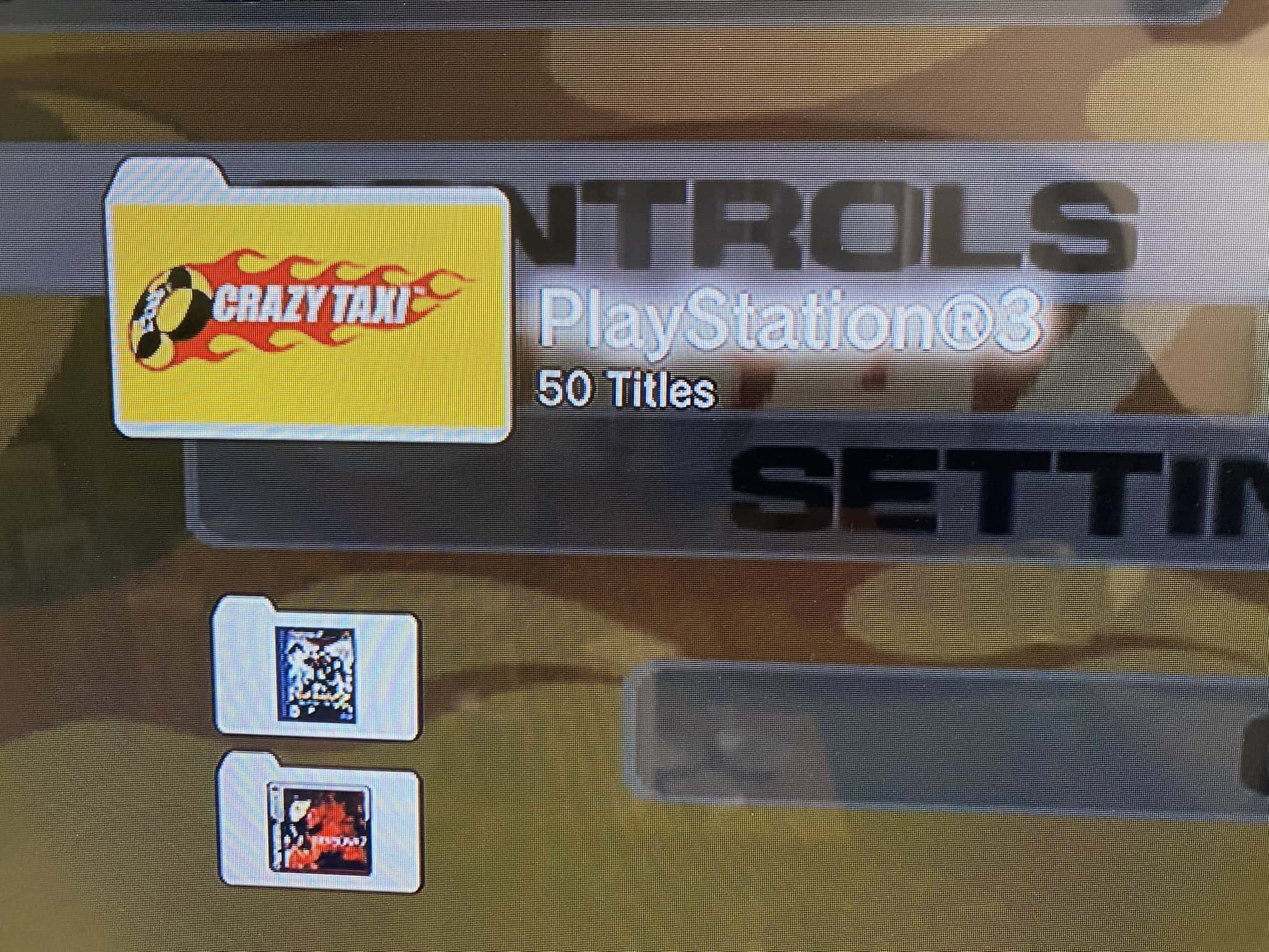 Screenshot of the PS3's dashboard, with Crazy Taxi's icon in the foreground and the Crazy Taxi menu in the background.