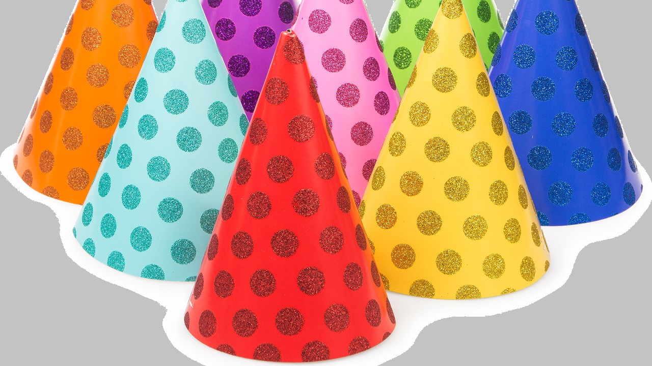 An assortment of eight polka dot-patterned party hats, each of them in different colors