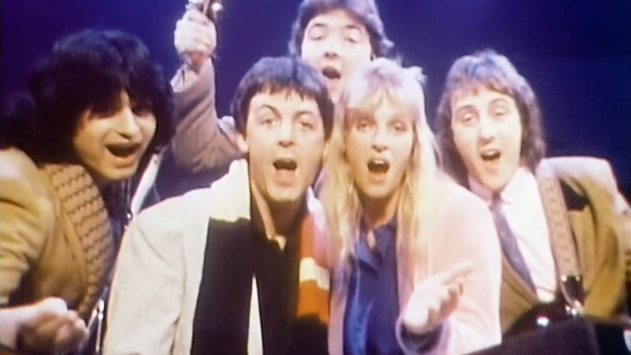 Image still from the end of the "Wonderful Christmastime" music video, featuring Paul McCartney and members of his band, Wings